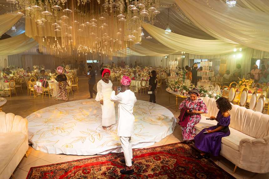 Guests on the round dance floor beneath the chandeliers.